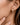 18K Gold Plated Waterproof Stainless Steel Hoop Earrings 7112 worn on an ear to show their appearance