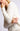 Close-up of model wearing Chiara white long-sleeve pullover sweater