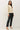 Side view of model wearing cream raglan sleeve slub pullover sweater