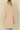 Back view of a woman wearing a Shop Wall beige long sleeve open front cardigan with a soft knit texture