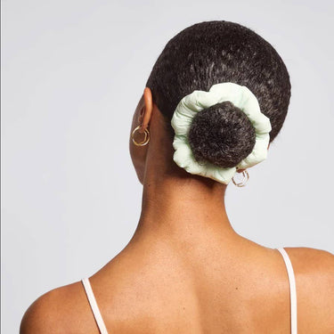 Model showcasing Cloud Scrunchies 3pc Set - Garden Bouquet with a stylish bun hairstyle.