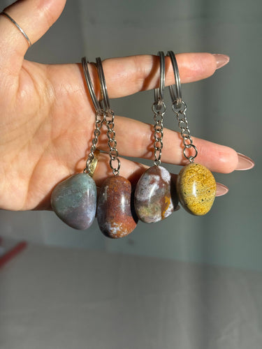 Ocean Jasper Crystal Keychain featuring polished multicolored gemstones with natural patterns displayed in a hand