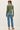 Back view of model wearing green Ultra Soft Basic Button Up Cardigan with blue jeans