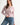 Pearl Button Ribbed Knit Cardigan in pink styled with denim jeans