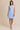 Light blue boat neck sleeveless side tie mini dress worn by a model, full-body view.