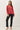Model wearing red raglan sleeve slub pullover sweater with black pants, front view