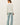 Back view of model wearing light-colored raglan sleeve pullover sweater