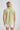 Back view of a woman wearing a COLLARED V NECK BUTTON DOWN LINE LACE DETAIL SHIRT in green with short sleeves.