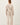 Back view of model wearing stone cotton modal fleece sweatshirt with matching pants