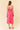 Back view of a model wearing the Two Tone Floral Button-Down Bodice Midi Dress in pink floral pattern.