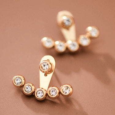 18K Gold Plated Stainless Steel White Crystal Ear Jacket Studs 7985 displayed as a pair on a brown background