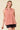 Model wearing a Striped Yoke Top in pink, showcasing the design and fit with a relaxed silhouette.