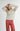 Model wearing Irisha Diamond Pointelle Sweater in Oatmeal,with hands behind head