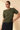 Model wearing cream ribbed knit top with brown pants