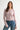 Pearl Button Ribbed Knit Cardigan in pink styled with denim jeans