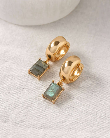 The Classic Form Labradorite Huggie Hoops featuring gold-plated design and faceted labradorite stones.