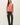 Front view of model wearing pink long sleeve top with black pants