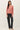 Front view of model wearing pink long sleeve top with black pants