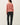 Back view of model wearing pink long sleeve top with black pants