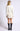 Back view of model wearing Chiara white long-sleeve pullover sweater