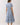 Back view of Embroidered Floral Tiered Button Down Midi Dress in blue with floral design and gathered waist.