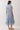 Back view of Embroidered Floral Tiered Button Down Midi Dress in blue with floral design and gathered waist.
