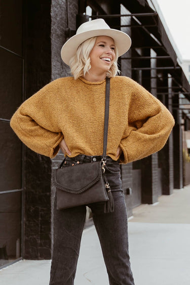 Flapover crossbody bag with whipstitch