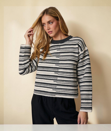 Round neck long-sleeve stripe sweater worn by a model with long hair against a neutral background.