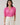 Model wearing Mirany Ikat Bindy Puff Sleeve Top with pink ikat print and puff sleeves, styled with high-waisted trousers.