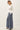 Side view of model wearing white Ultra Soft Essential Basic Crewneck Button Up Cardigan