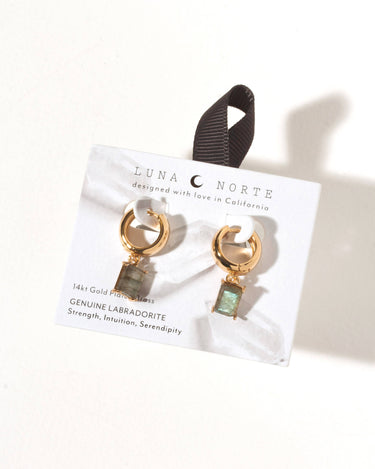 The Classic Form Labradorite Huggie Hoops on display, featuring genuine labradorite stones and 14KT gold plated brass.