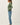 Side view of model wearing green Ultra Soft Basic Button Up Cardigan with blue jeans