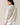 Back view of model wearing beige melange Half Zip Funnel Neck Long Sleeve Pullover Top