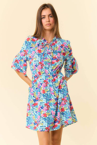 Floral Printed Split V-Neck Half Bell Sleeve Dress displayed on a model, showcasing vibrant floral patterns and ruffle details.