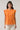 Model wearing Donna Dot Hessi Button Down Top in a front view with light-colored pants