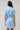 Back view of Saida Striped Kenda Shift Mini Dress in blue and white stripes featuring a drawstring waist and short sleeves.