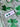 Shamrock Clay Studs Shamrock Stud Earrings displayed on a green clover background, showcasing the lightweight polymer clay design.