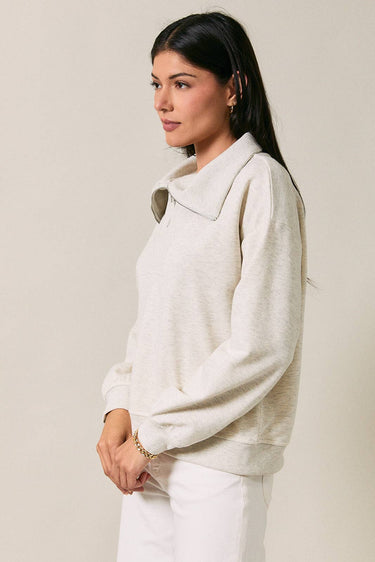 Side view of model wearing beige melange Half Zip Funnel Neck Long Sleeve Pullover Top