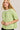 Close-up view of model wearing green short sleeve sweater cardigan