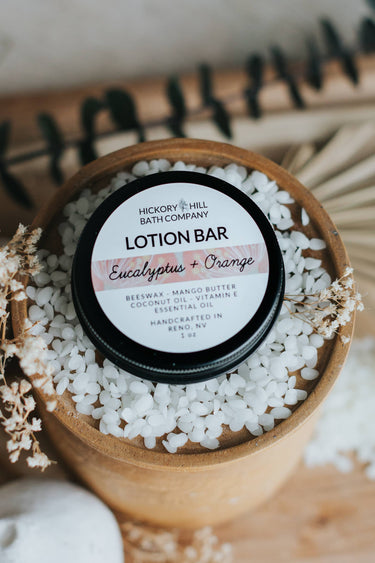 Eucalyptus Orange Beeswax Lotion Bar in round packaging