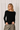 Model wearing black Boat Neck Semi Bell Long Sleeve Knit Top with casual pants