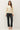 Full-length view of model wearing cream raglan sleeve pullover sweater with black pants