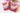 Red Feathers Organic Artisan Soap bars with floral background, showcasing natural colors and artisan design.