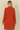 Back view of Shop Wall rust orange long sleeve open front cardigan with side pockets on a model