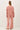 Model wearing pink cotton modal fleece sweatshirt, back view