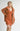 Model wearing Elianna rust wide collar cardigan with shorts