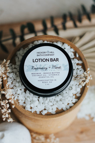 Rosemary Mint Beeswax Lotion Bar in round packaging