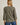Back view of model wearing olive green Round Neck 3-4 Sleeve Top with blue jeans