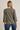 Back view of model wearing olive green Round Neck 3-4 Sleeve Top with blue jeans