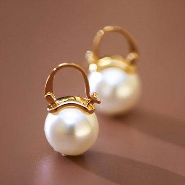 18K Gold PVD Plated Stainless Steel Pearl Drop Earrings 8036 displayed as a pair on a brown background